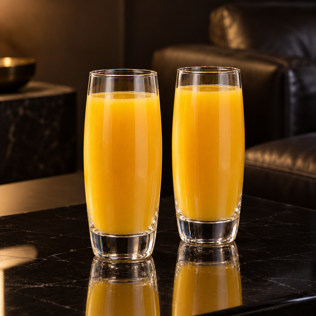 Highball glasses with mango juice in living room